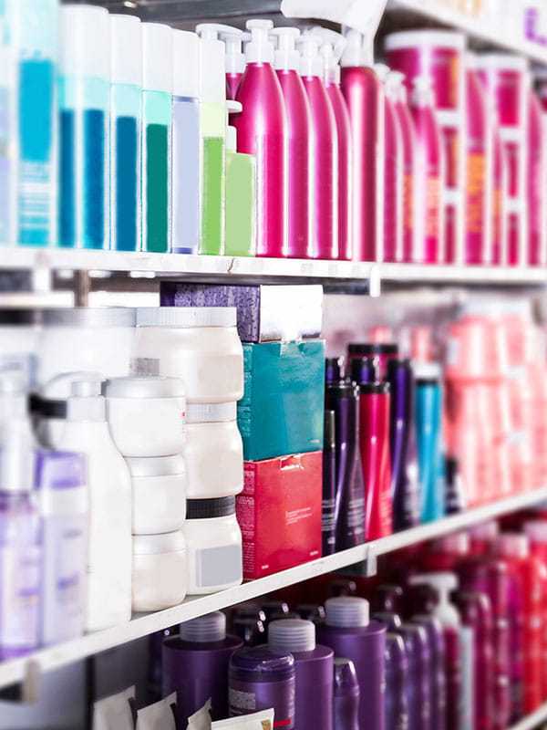 Shelves filled with assorted colorful hair care and beauty products.